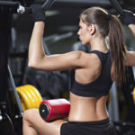 Woman exercising on weightlifting machine